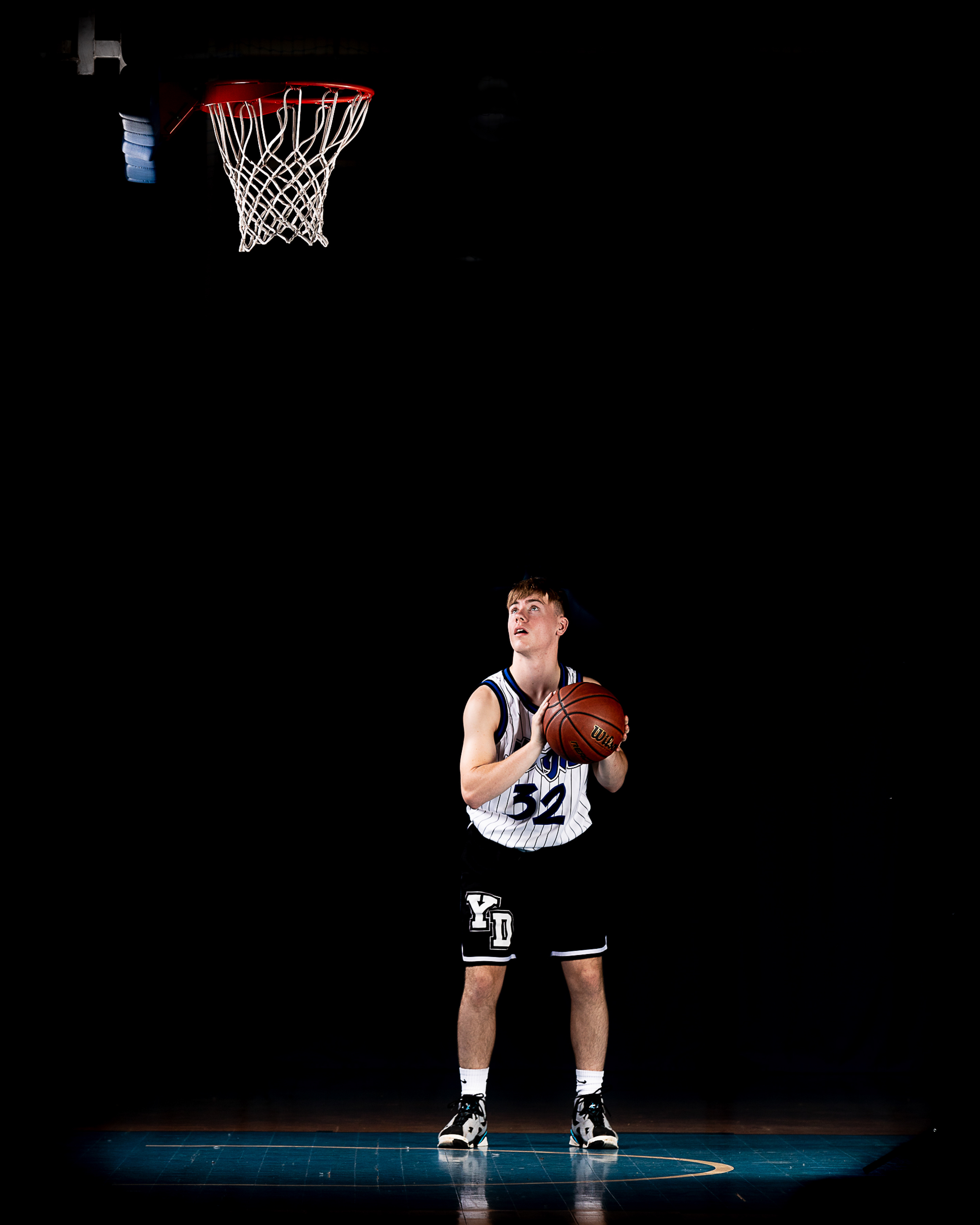 Basketball player under the hoop.